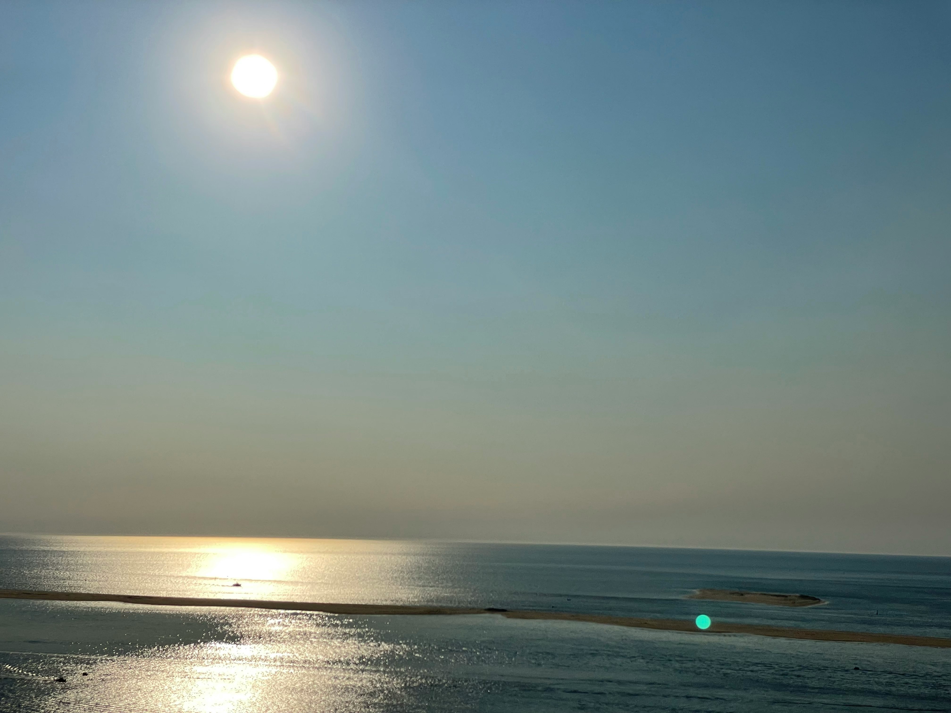 body of water under sunny sky